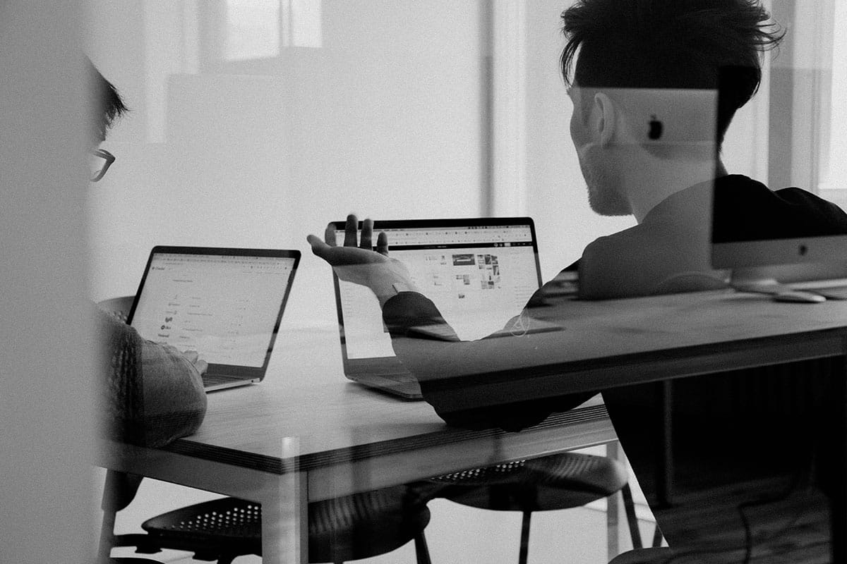 An asian talking to his colleague